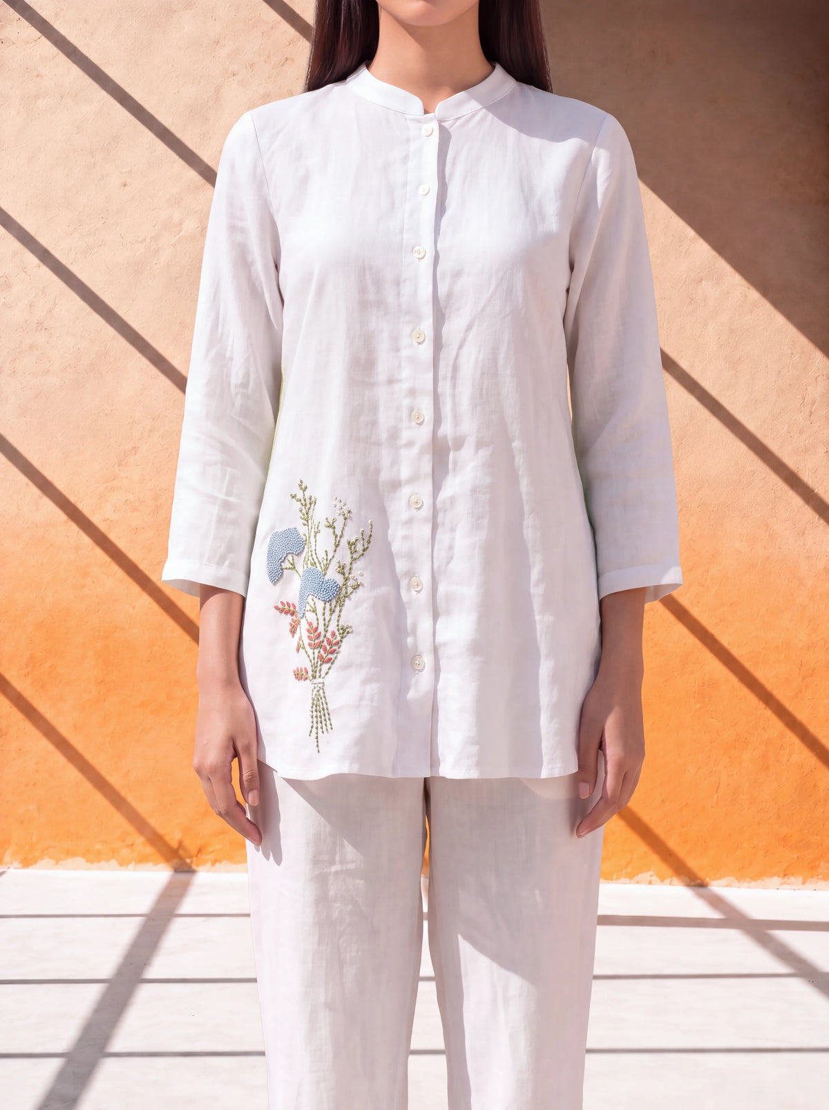 White linen coordinate set with floral embroidery and handworked back design